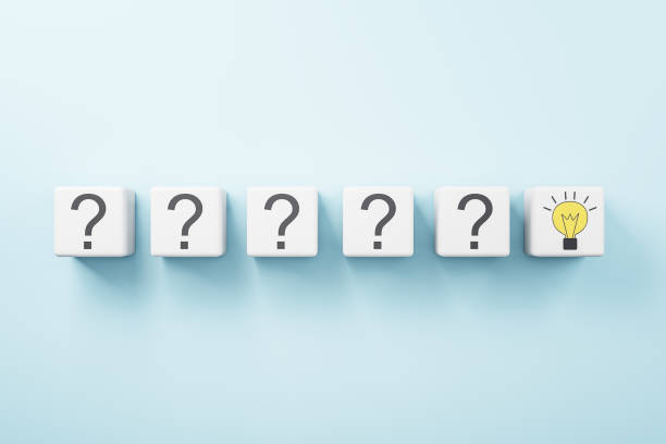 Idea concept with row of white cubes with question mark and one with yellow light bulb on blue background stock photo