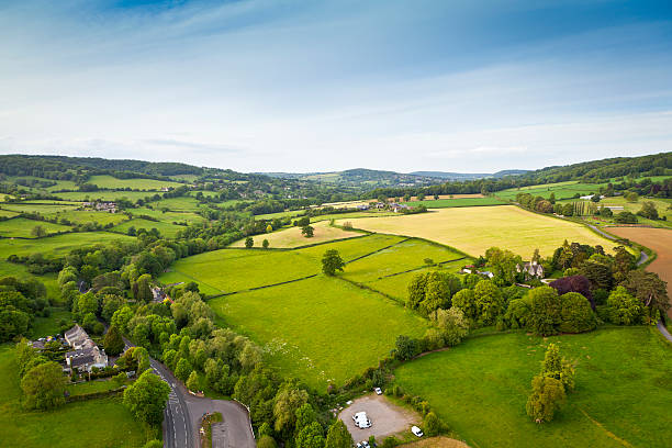 Idyllic rural, aerial view, Cotswolds UK Dramatic aerial view of gently rolling patchwork farmland with pretty wooded boundaries, in the beautiful surroundings of the Cotswolds, England, UK. Stitched panoramic image. copse stock pictures, royalty-free photos & images