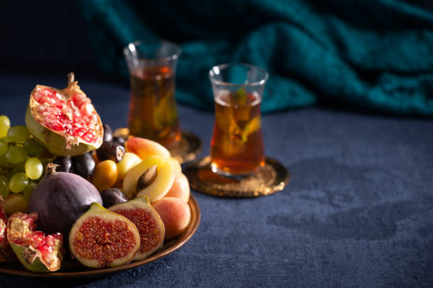 Iftar arrangement with fresh fruits, sweets and tea stock photo
