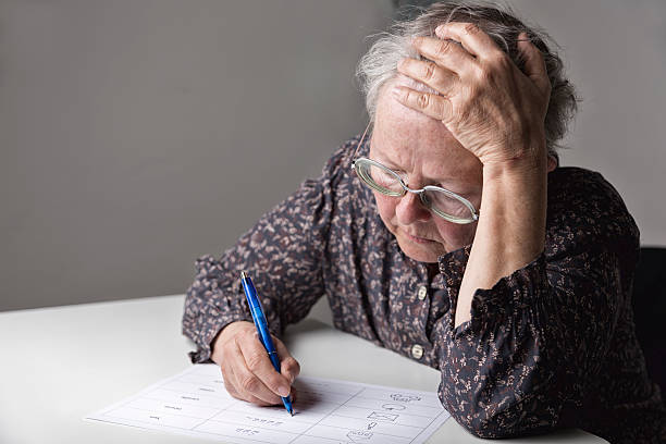 Illiterate woman learning to write stock photo