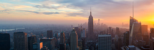 Illuminated Empire State and New York's skyline at night stock photo