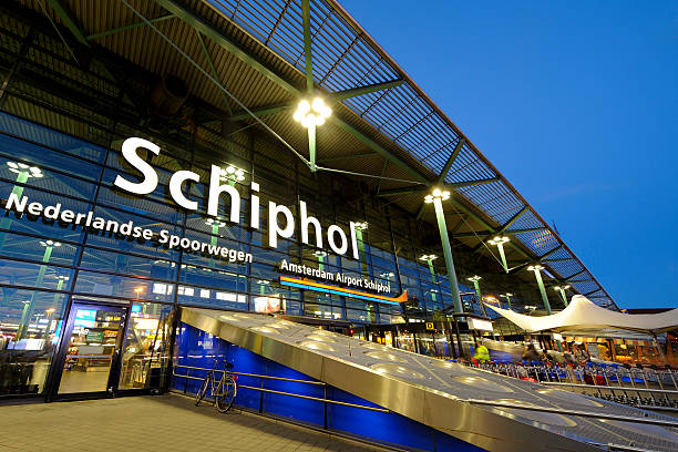 illuminated entrance of amsterdam airport schiphol at night - schiphol stockfoto's en -beelden