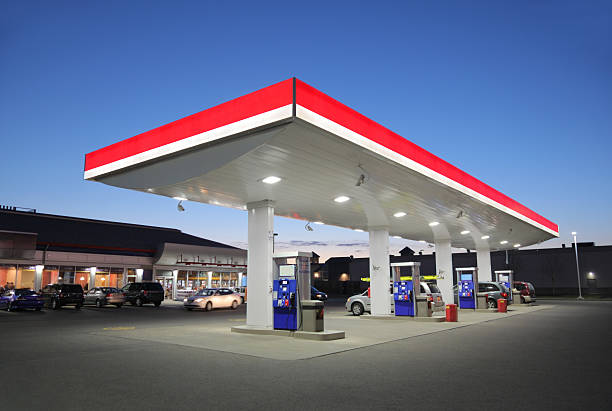 Illuminated Gas Station at Sunset stock photo