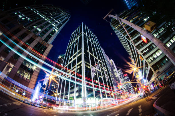 illuminated skyscraper and light trail at night new york city at night. fish-eye lens long exposure fish eye lens stock pictures, royalty-free photos & images