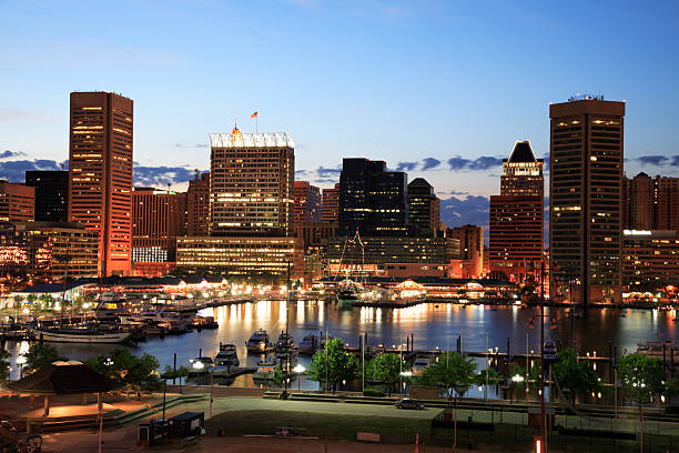 Illuminated skyscrapers of Inner Harbor, Baltimore, Maryland Baltimore's Inner Harbor was a major industrial port from the 1700s.  Redeveloped in the 1970s, the Inner Harbor is now one of Maryland's major tourist destinations.  One of the major attractions is the National Aquarium which was opened in 1981.  baltimore maryland stock pictures, royalty-free photos & images