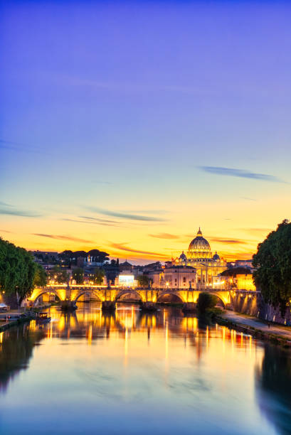 Illuminated St. Peter's Cathedral in Rome at Dusk, Italy stock photo