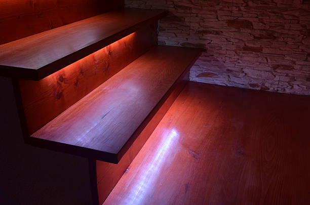 Illuminated wooden stairs stock photo