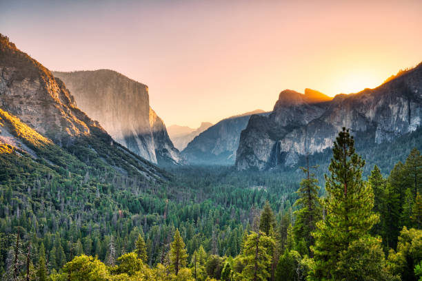 Illuminated Yosemite Valley view from the Tunnel Entrance to the Valley at Sunrise, Yosemite National Park, California stock photo