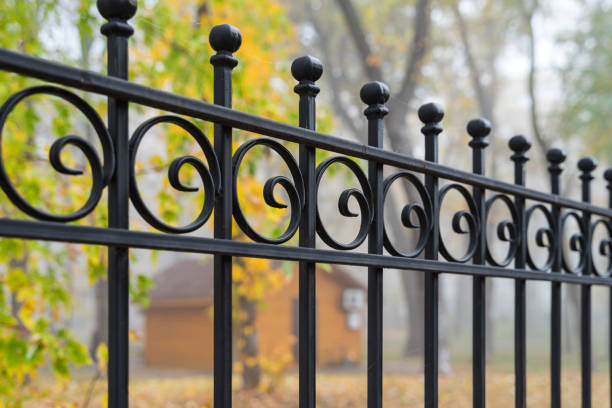 Image of a Beautiful decorative cast iron wrought fence with artistic forging. Metal guardrail close up. stock photo