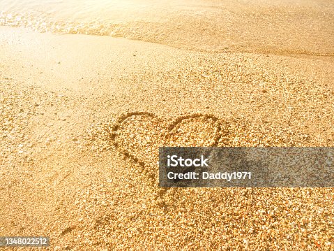 istock Image of a heart in the sand 1348022512