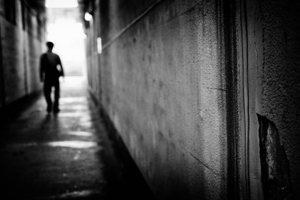 Image of a man walking in a tunnel, Monochrome stock photo