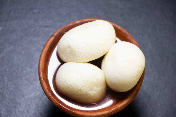 Image of Rasgulla or Rosogolla or Rosgola or Rasagola is a South Asian syrupy dessert popular in the Indian subcontinent Image of Rasgulla or Rosogolla or Rosgola or Rasagola is a South Asian syrupy dessert popular in the Indian subcontinent bengali sweets stock pictures, royalty-free photos & images