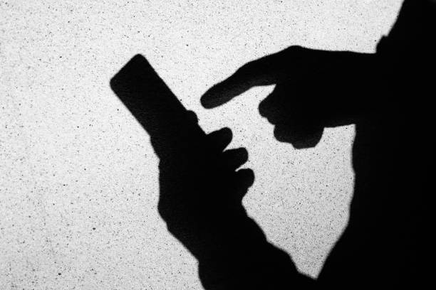 Image of the shadow of the person who operates the smartphone stock photo