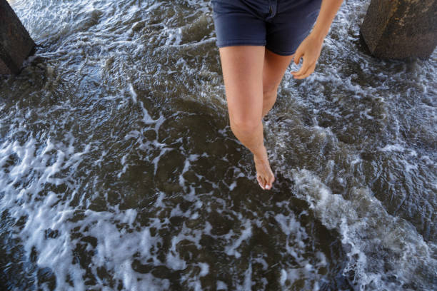 Image of woman legs waking in sea water. Summer time in north of Peru. Image of woman legs waking in sea water. Summer time in north of Peru. hot peruvian women stock pictures, royalty-free photos & images