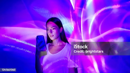istock Image projection on a woman using a smart phone 1341661060