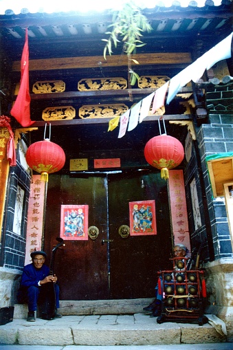 In the Old Town of Lijiang, the Naxi Ancient Music Association organized by Mr. Xuan Ke has a performance every night, and many tourists come to watch show. Between about 2002 -2012, there were times when a single vote was hard to come by. Now that Mr Xuanke is too old and can't  host the show, the audience is much smaller..Film photo in July 1998,Lijiang,Yunnan
