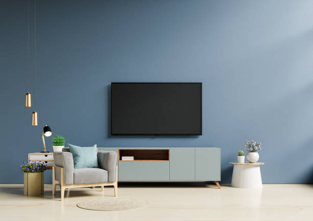 tv in modern living room with armchair have empty dark blue wall background. - camisetas futbol 個照片及圖片檔