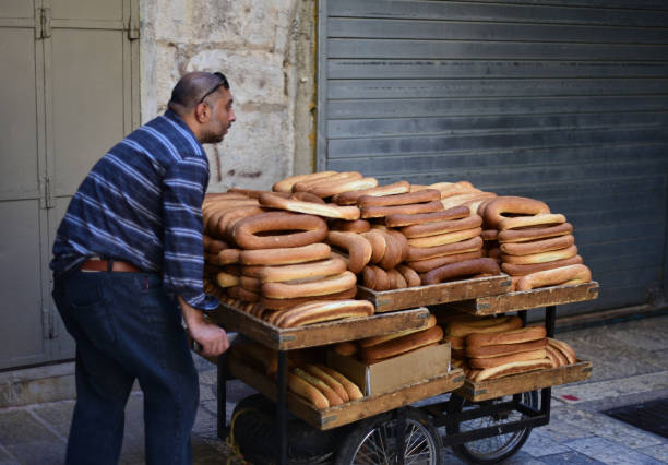 In the early morning, a worker delivers all the bagels to sellers in the market. stock photo