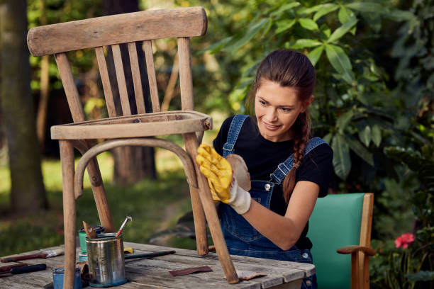 DIY in the garden. Grinding wooden chair stock photo