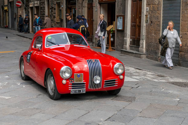Florence, Italy - May 7, 2010: FIAT 1100 S (1948) in the rally Mille Miglia 2010 edition on a busy street in Florence. stock photo