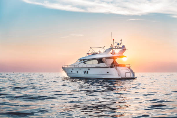 In the sunset Yacht in the sunset on the sea motorboat stock pictures, royalty-free photos & images