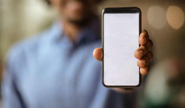 In today's time without technology there is no progress in anyone. Time when it is impossible without technology. Business man holding smart phone. Focus is on hand. blank screen stock pictures, royalty-free photos & images
