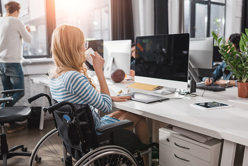 Incapacitated Person In Wheelchair Working At Modern Office Stock Photo ...