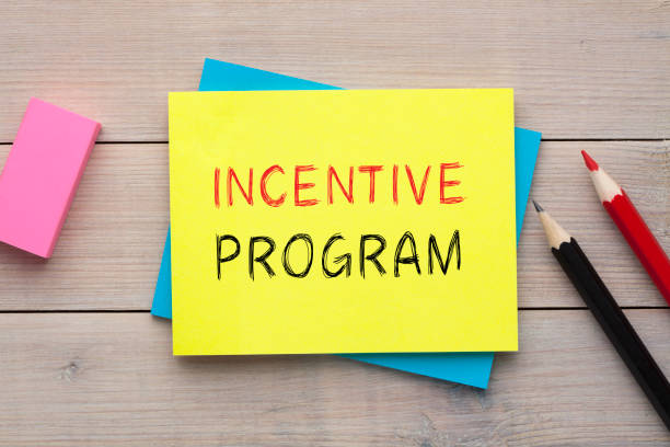 Incentive Program Concept Incentive Program written on the note with  colorful pencils and eraser aside on wooden desk. Top view incentive stock pictures, royalty-free photos & images
