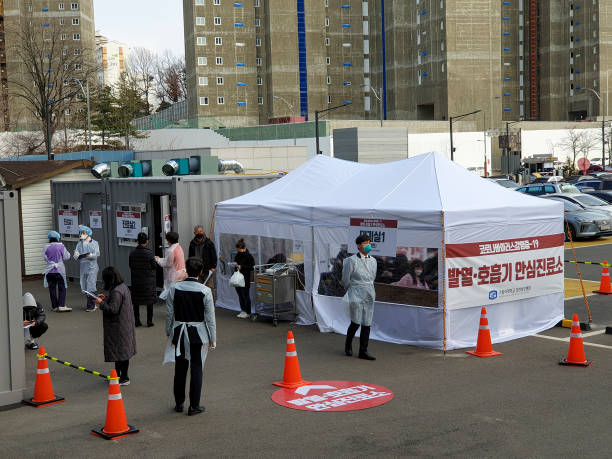 February 26, 2020.
Outpatient Clinic, Incheon St. Mary's Hospital, Catholic University of Korea.

Patients suspected of having COVID-19 infection are waiting to be screened at an outpatient screening clinic installed in the parking lot of Incheon St. Mary's Hospital.