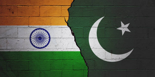 India vs Pakistan Cracked brick wall painted with a Indian flag on the left and a Pakistani flag on the right. pakistani flag stock pictures, royalty-free photos & images