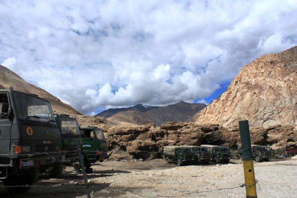 Indian Army Trucks Pangong Tso, Ladakh, Kashmir, India -August 15, 2012 : Indian army trucks parked near Pangong Tso area.Pangong Tso or Pangong Lake  is an endorheic lake in the Himalayas situated at a height of about 4,350 m (14,270 ft). It is 134 km (83 mi) long and extends from India to the Tibetan Autonomous Region, China. Approximately 60% of the length of the lake lies within the Tibetan Autonomous Region. The lake is 5 km (3.1 mi) wide at its broadest point. All together it covers 604 km2. During winter the lake freezes completely, despite being saline water. It is not a part of the Indus river basin area and geographically a separate landlocked river basin. ladakh region stock pictures, royalty-free photos & images