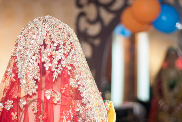 Indian bride looks at her reflection in a mirror Indian bride looks at her reflection in a mirror during a Hindu wedding in Dehradun Uttarakhand indian bride stock pictures, royalty-free photos & images