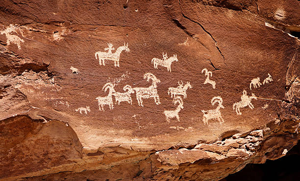 Indian Cave Painting Petroglyph 19th century indian petroglyph art photographed on public land in Southern Utah. cave photos stock pictures, royalty-free photos & images