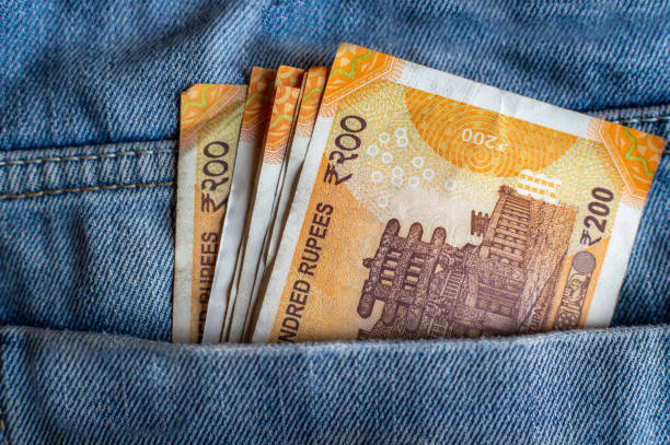 Indian currency Rs 200 notes in the pocket of a jeans Indian currency Rs 200 notes in the pocket of a jeans indian currency stock pictures, royalty-free photos & images