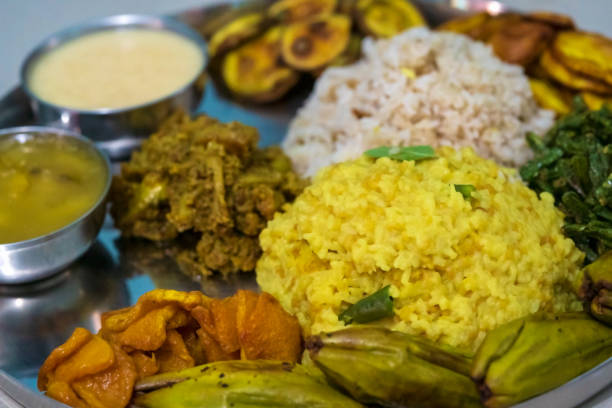 Indian Festve Foods Traditional Bengali dishes for Indian Hindu Durga Puja or pooja festive food. A plate full of khichdi, pulao, curry, payesh and some fries. bengali sweets stock pictures, royalty-free photos & images