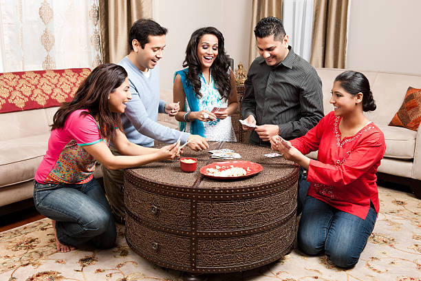 Indian Friends Playing Cards at Home Coffee Table fotos e imágenes de stock