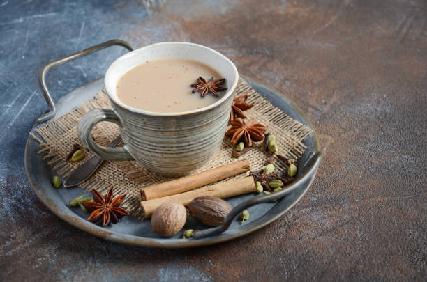 Indian masala chai tea. Spiced tea with milk on dark rusty background. Indian masala chai tea. Spiced tea with milk on dark rusty background. Selective focus. bengali sweets stock pictures, royalty-free photos & images