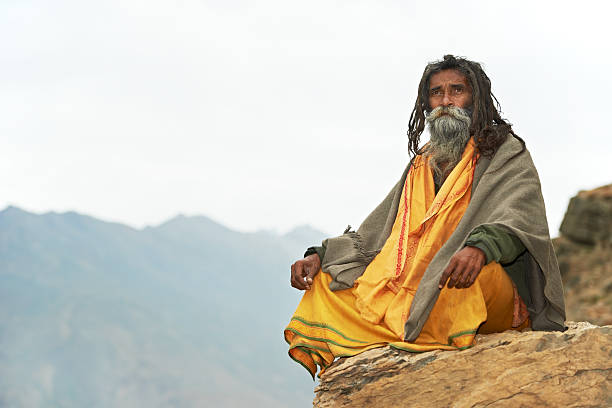 Indian monk sadhu Indian old monk sadhu in saffron color clothing sage stock pictures, royalty-free photos & images