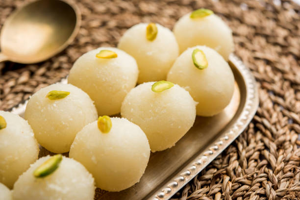 Indian Rasgulla or dry Rosogulla dessert/sweet served in a bowl. selective focus Indian Rasgulla or dry Rosogulla dessert/sweet served in a bowl. selective focus bengali sweets stock pictures, royalty-free photos & images