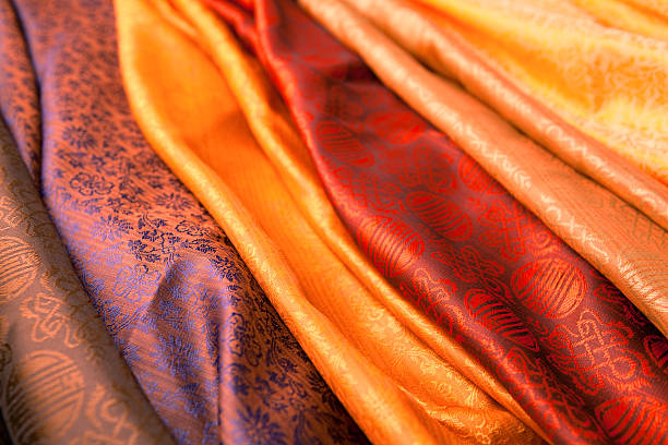 Indian scarves in many colors for display Silk scarves from India in a marketplace. silk stock pictures, royalty-free photos & images