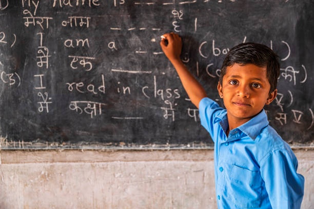 Indian schoolboy in classroom Indian schoolboy in classroom, English language class, Rajasthan, India languages  stock pictures, royalty-free photos & images