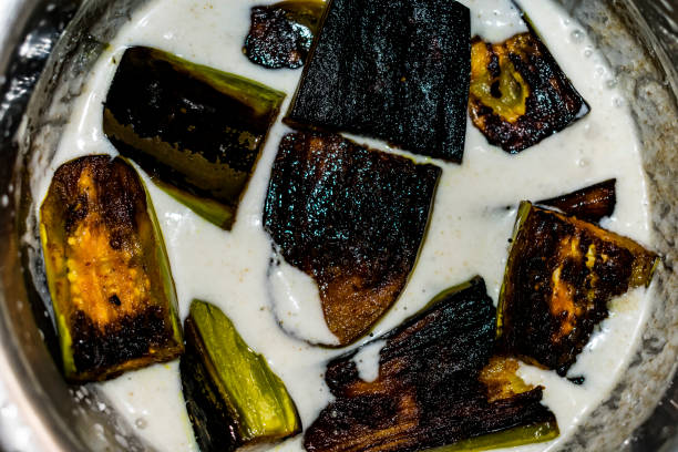 indian special food brinjal curd curry with awesome taste looking awesome in oil fried by curry leafs, red chili, cumin, mustard seeds, Fenugreek seed. stock photo