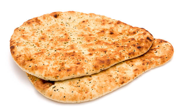 Indian style naan bread on a white background Indian style naan bread isolated on a white background. Naan bread is commonly eaten alongside curry. naan bread stock pictures, royalty-free photos & images