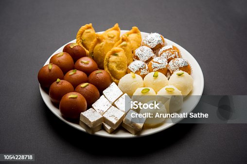 istock Indian sweets in a plate includes Gulab Jamun, Rasgulla, kaju katli, morichoor / Bundi Laddu, Gujiya or Karanji for diwali celebration 1054228718