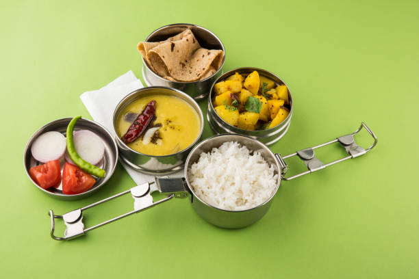 indian vegetarian office or school lunch box or tiffin with north or picture