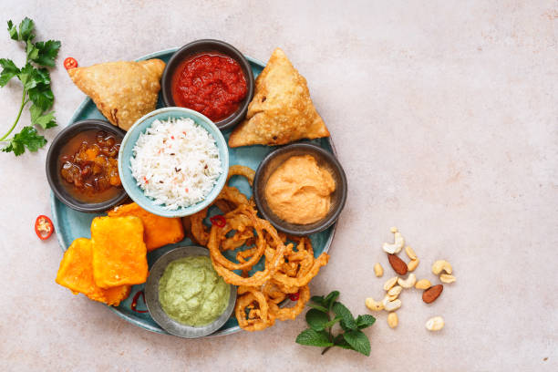 Indian vegetarian thali  with jeera  rice, different snacks and dips Indian vegetarian thali  with jeera  rice, different snacks and dips. Top view, blank space indian food stock pictures, royalty-free photos & images