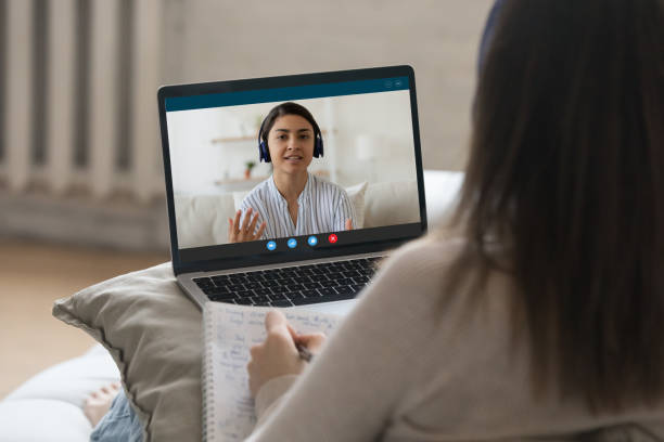 Indian woman talks to university mate, studying together use videocall stock photo