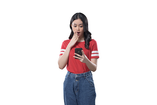 Indonesian woman on greenscreen backgroud_surprise when looking at her phone