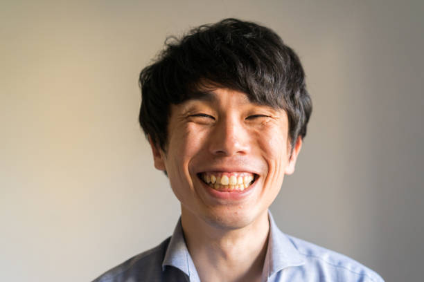 Indoor portrait of a Japanese man in his thirties in a blue shirt stock photo