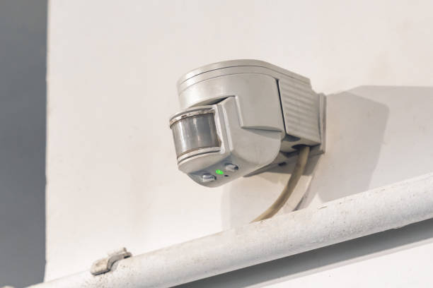 Indoor wall motion or light sensor for indoor lighting control stock photo